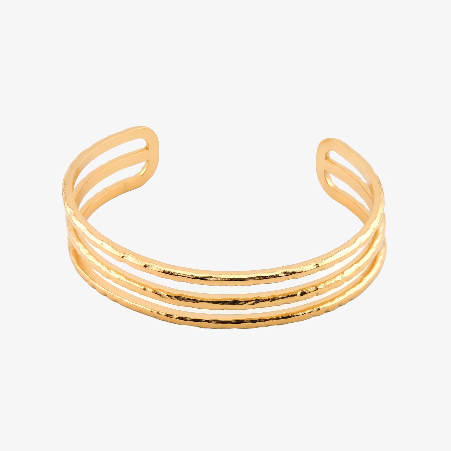 BRAZALETE FABIOLA. Brazalete rígido ajustable de acero inoxidable bañado en oro de 18k