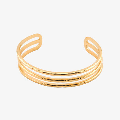 BRAZALETE FABIOLA. Brazalete rígido ajustable de acero inoxidable bañado en oro de 18k