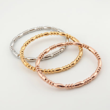 BRAZALETE ALMA. Pulsera brazalete rígido de acero inoxidable bañado en oro rosa