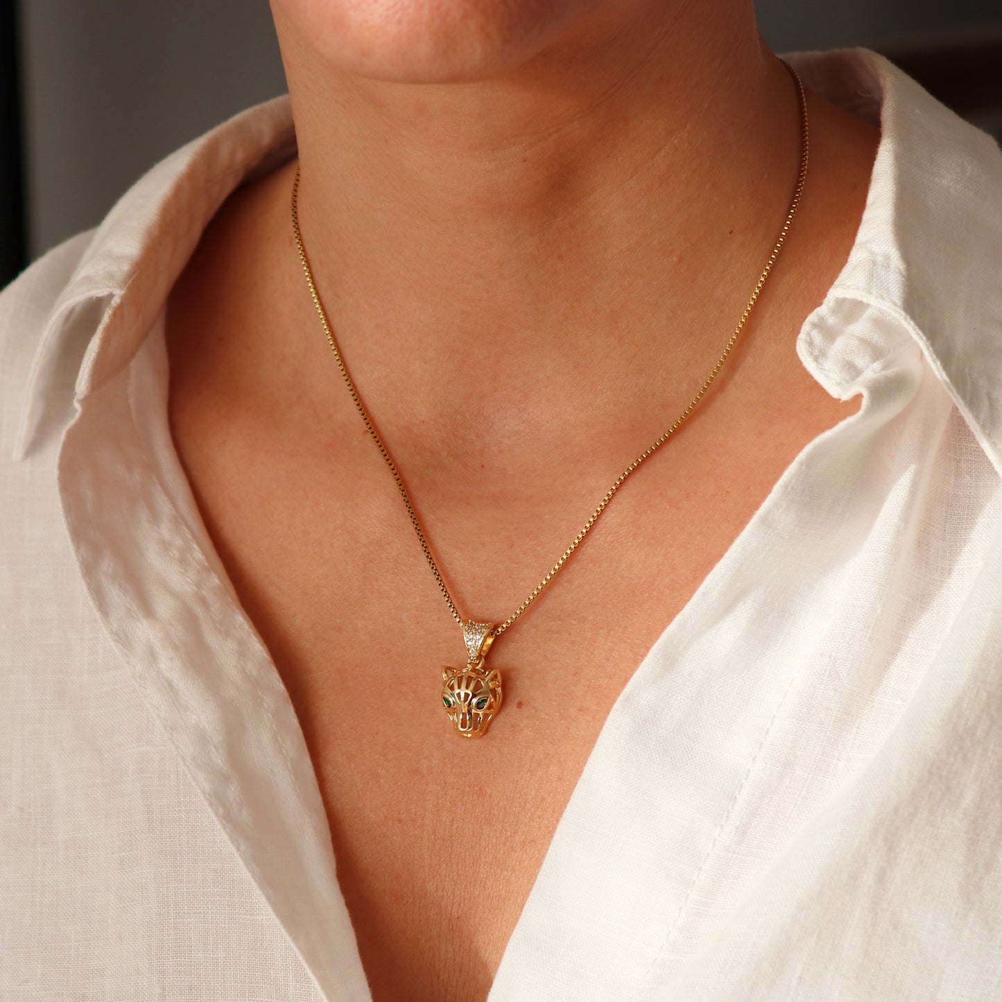 COLLAR LEONOR. Collar de acero inoxidable recubierto de titanio bañado en oro de 18k y colgante con forma de pantera con detalles de circonitas