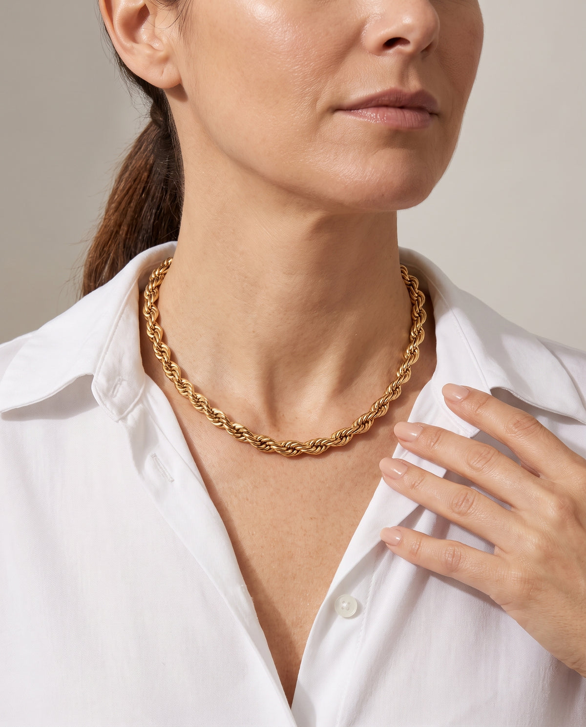 Collar Hazel, cadena de cordón trenzado dorada, puesta en el cuello con camisa blanca